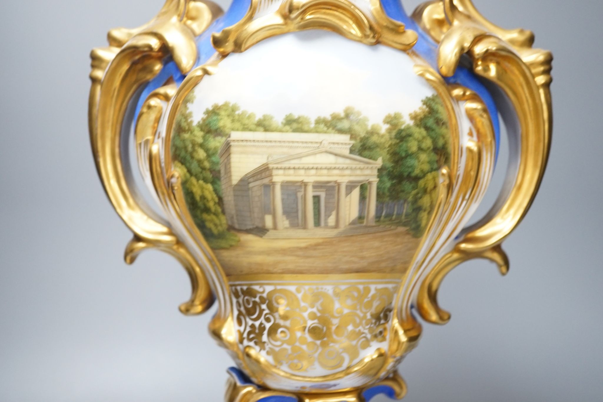 An early 19th century Paris porcelain vase in Feuillet style painted with a folly 44cm